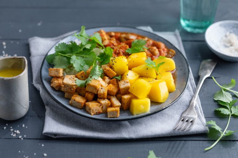 Exotic salad bowl with mango tofu and nuts